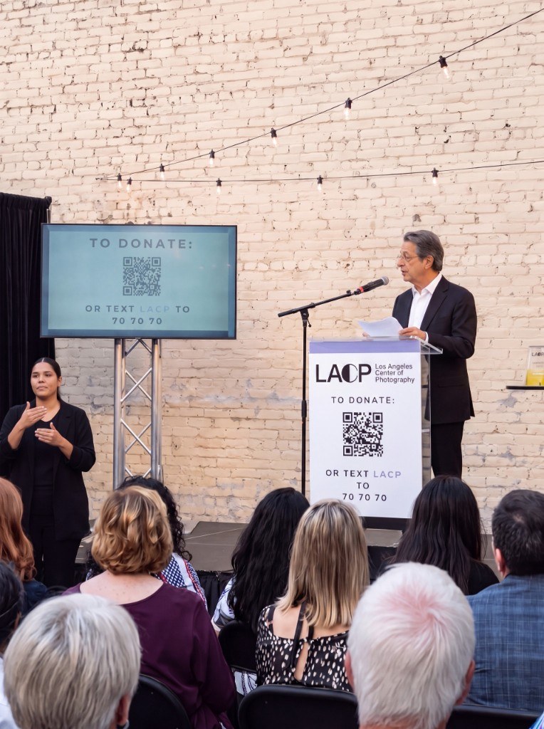 Egemen Mustafa Şener — speaking at a podium, audience in front
